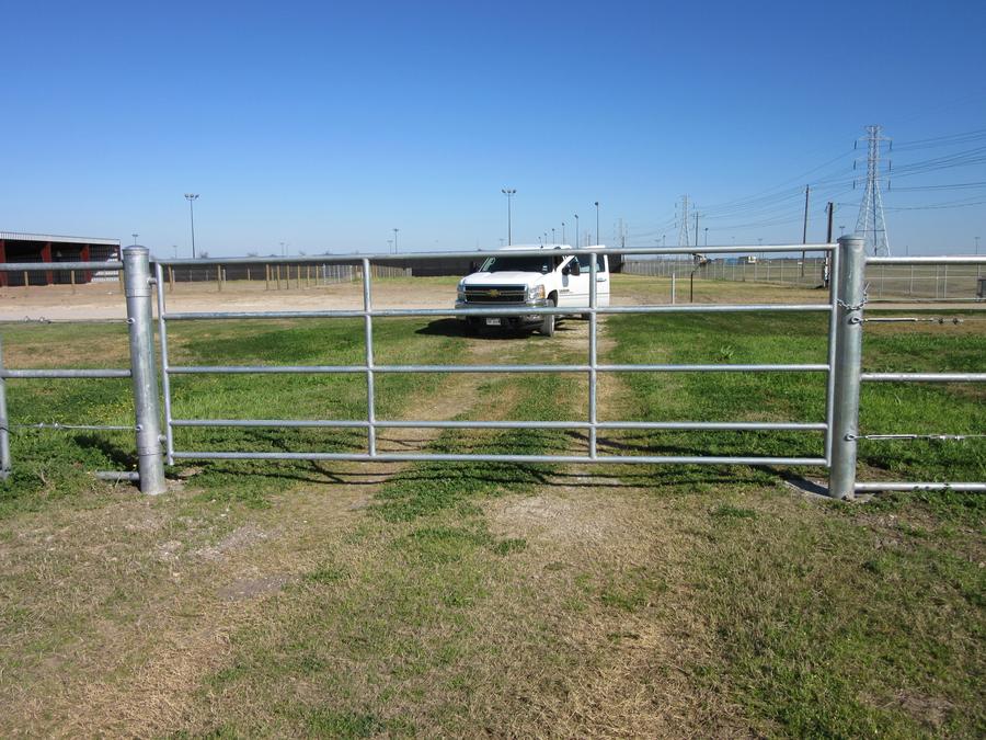 Galvanized pipe drive gate and framework on an open lot